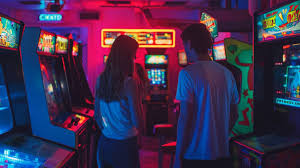 A boy and girl in a arcade with machines near them 
