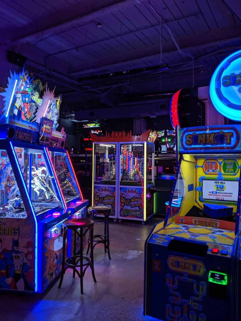 Arcade machines displaying games with bright lights.